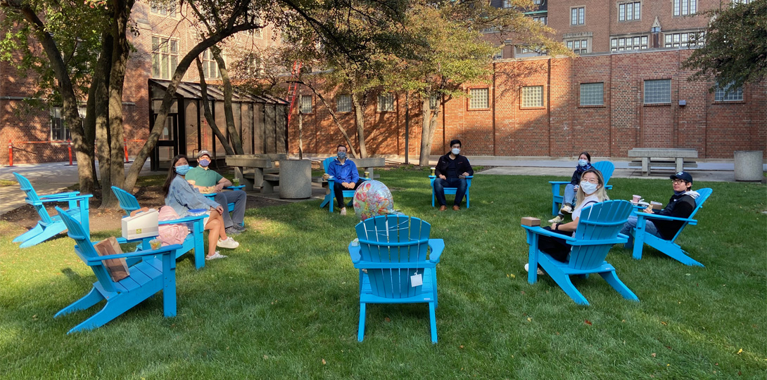 2020 Naba lab members in Adirondack chairs on the lawn outside COMRB