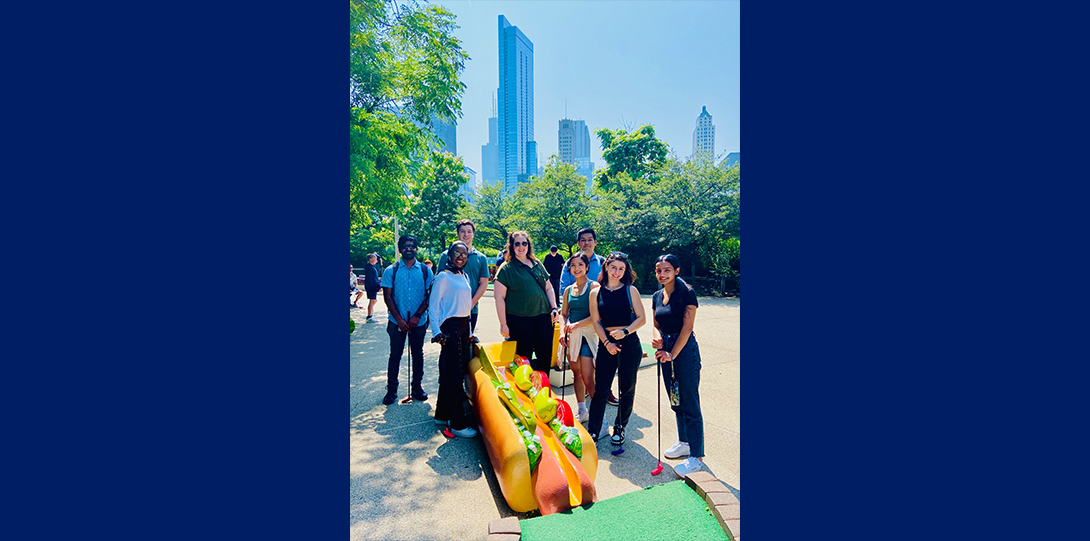 2023 Naba lab members in front of a Chicago-style hot dog themed mini golf hole