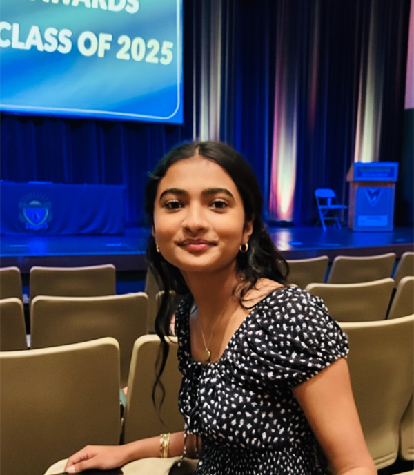 Prakrti Senthil seated in an auditorium