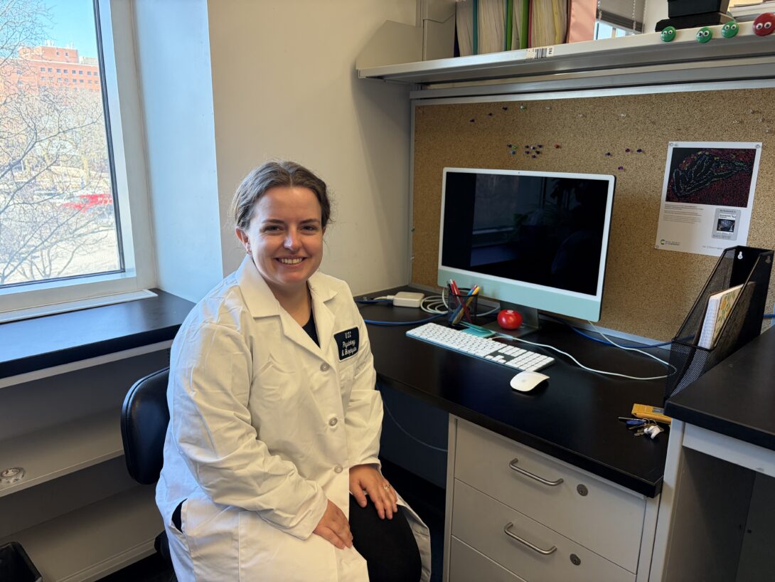Krista seated at her desk in the lab